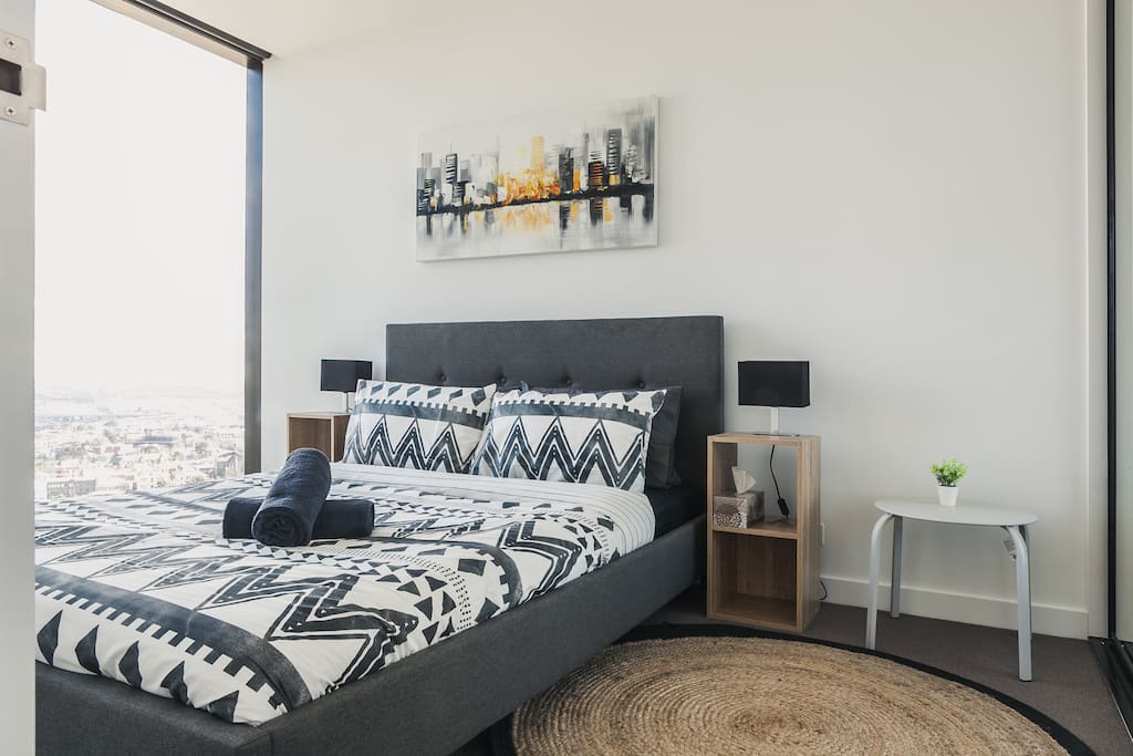 Well appointed bedroom with queen size bed, floor to ceiling glass panel closets and amazing views
