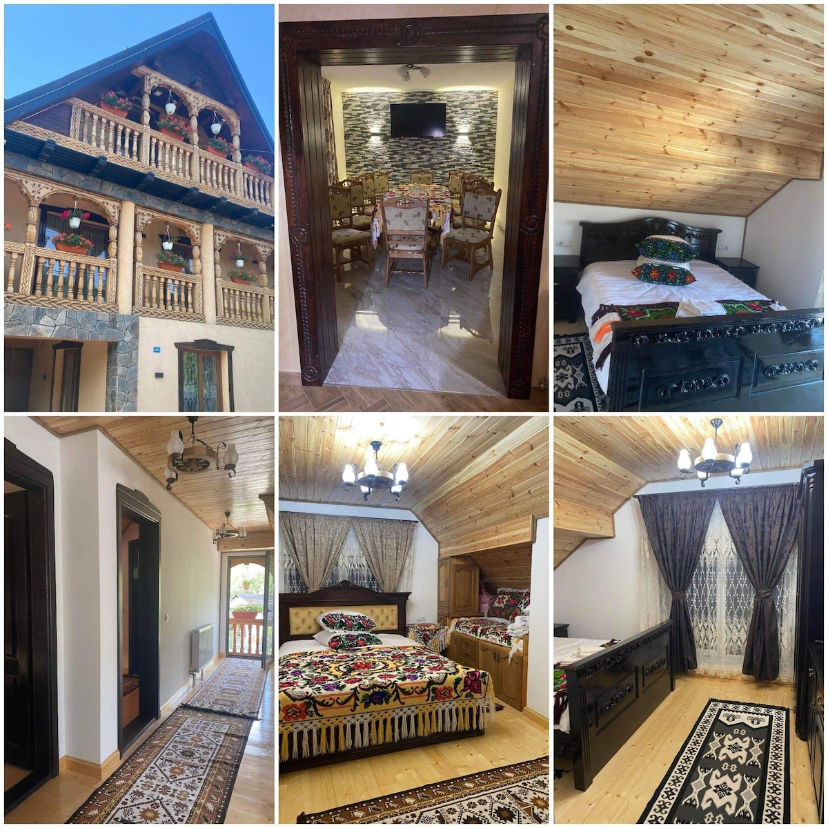 A charming wooden structure features detailed woodwork and decorative elements. Inside, a cozy dining area with a stone accent wall is visible, alongside elegantly furnished sleeping areas adorned with colorful textiles. Natural light streams through large windows, enhancing the warm ambiance of the space.
