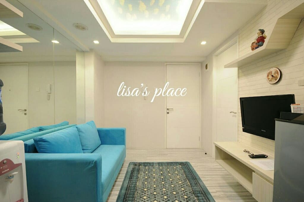 Living room, blue cloud wall paper in the ceiling.. comfort blue sofa for enjoying TV Program.