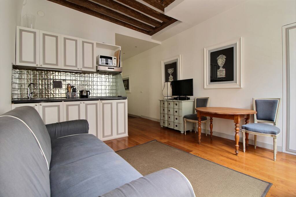 Luminous living room with sofa and dining area