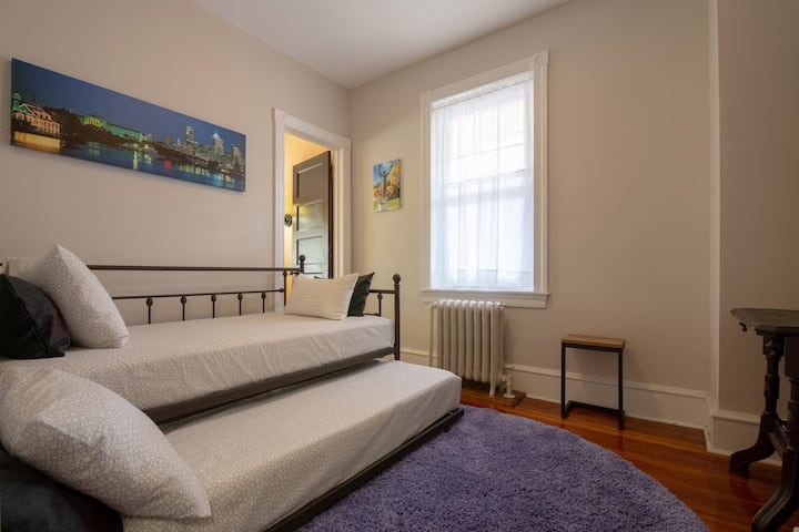 Second Bedroom. Twin bed & twin trundle bed. 2 side tables. Seating. Wall mirror. Accent lighting. Thick periwinkle area rug. Closet with extra linens. Pajama party time!