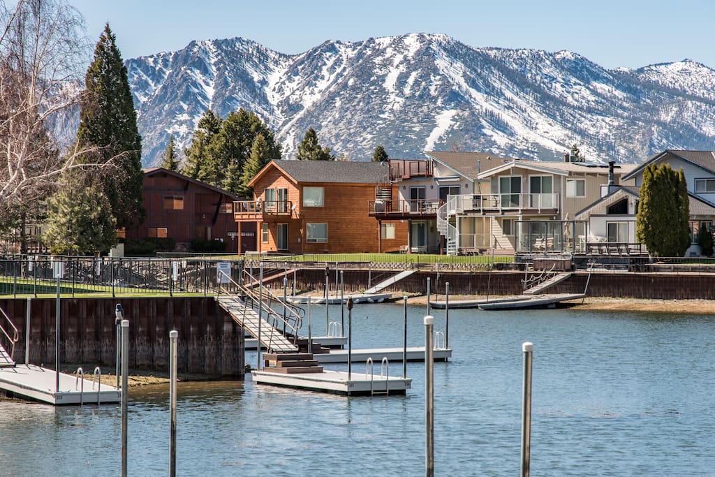 Majestic mountains rise over your private boat dock.