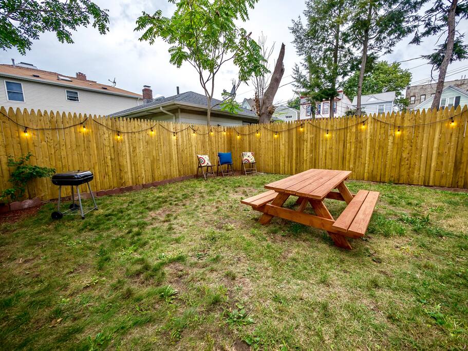 Enjoy our large backyard common space with fairy lights and picnic table.