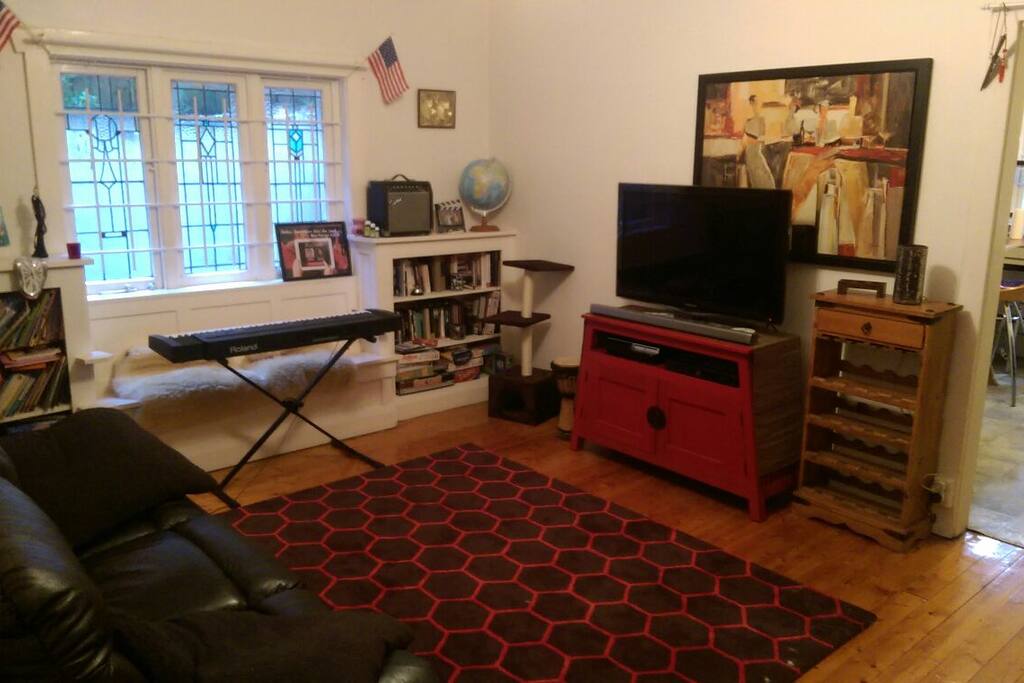Living space with reclining leather sofa and chair plus a desk and work space.