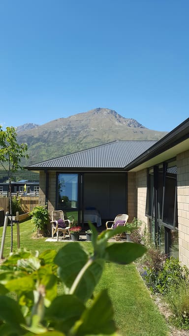 From garden looking onto bedroom, with The Remarkables mountain range in background