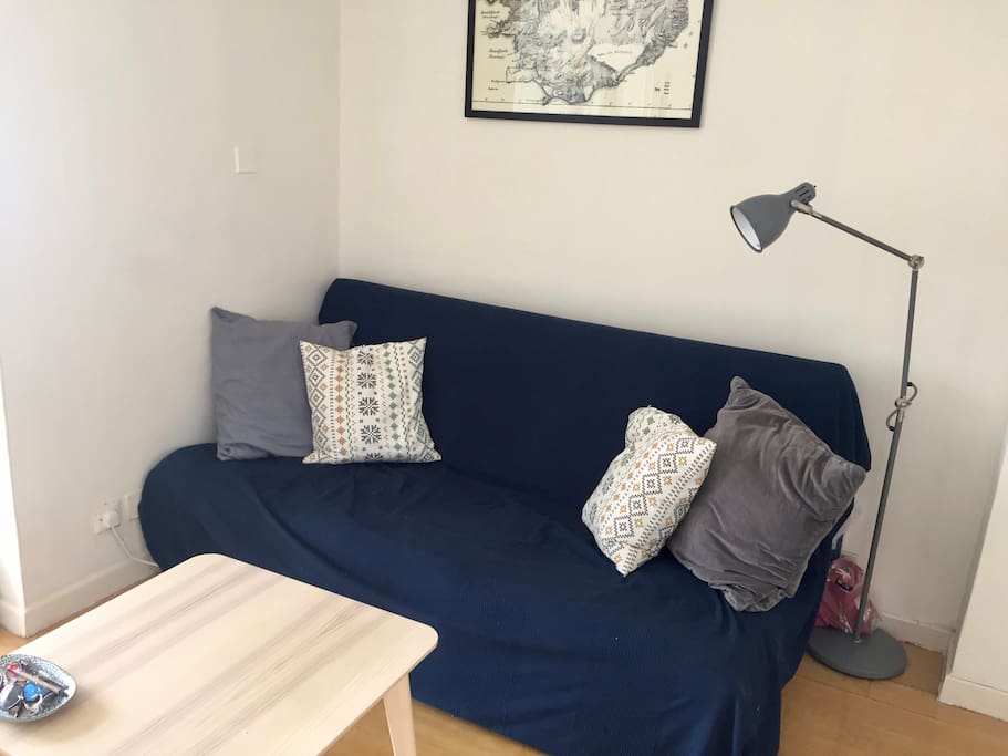 Futon in living space converts to a queen size bed