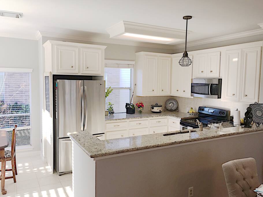 Open floor plan with kitchen off of main living area - surrounded by tons of windows!