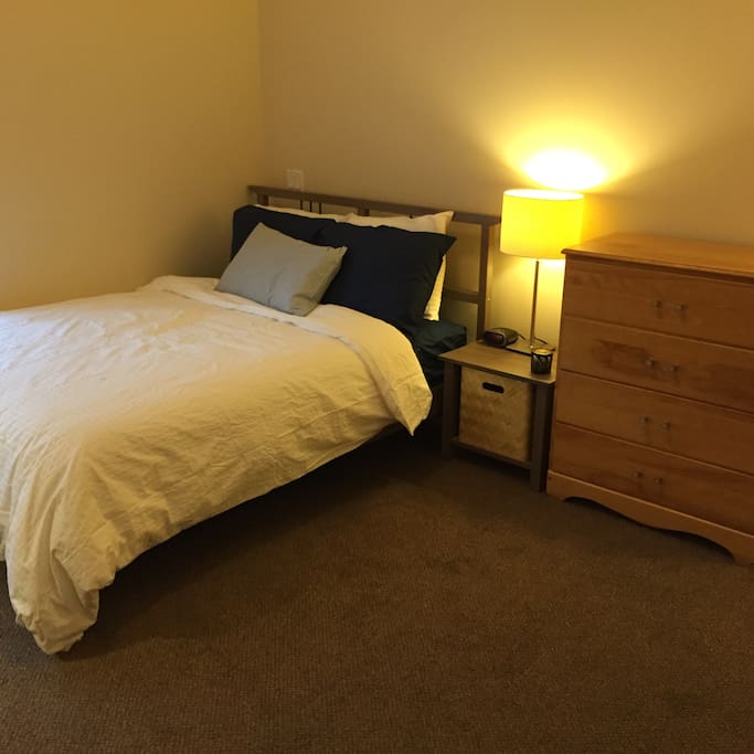 This is your bedroom. This is a double bed, and the dresser is empty for your use.