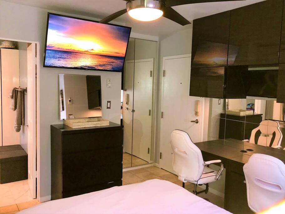 Studio with large TV, custom closet, bathroom