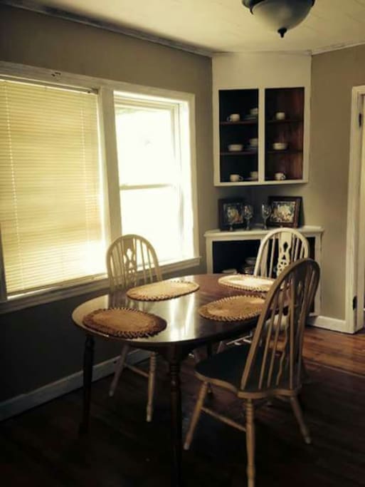 Dining table right inside the kitchen. An extension allows the table to easily seat 6. There are 6 chairs for the table and all the china and eating utensils to feed more than six.