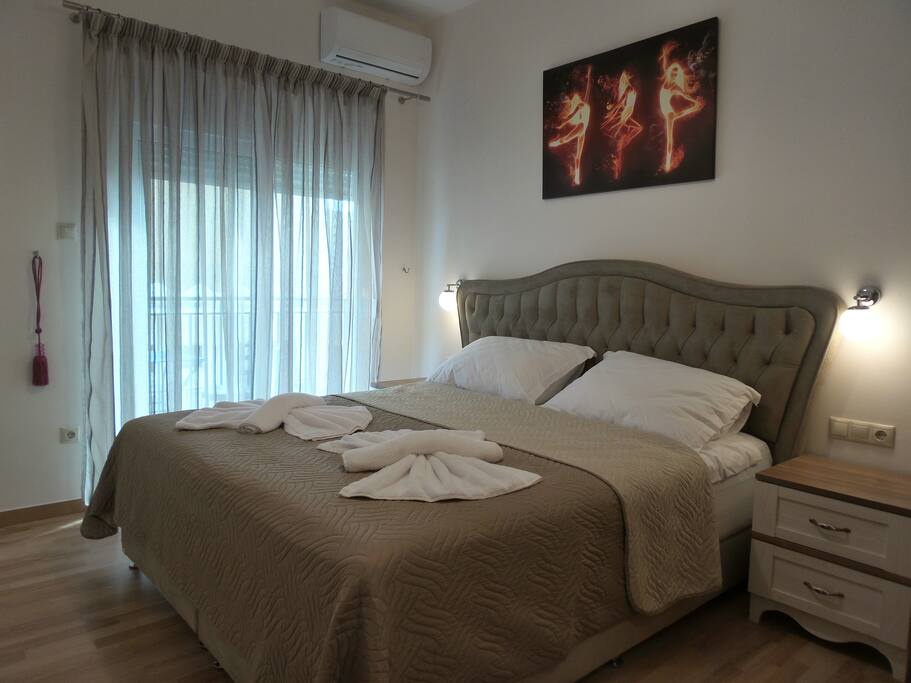The double-bedded bedroom features its private balcony with outdoor furniture