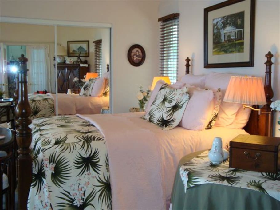 Spacious master suite with California queen bed, sitting area and flat screen TV.