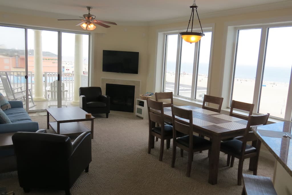 The living room with balcony access and views of the ocean, bay, and boardwalk.