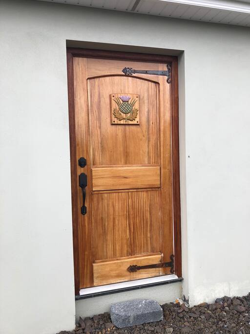 Handmade wooden front door with Thistle logo!
