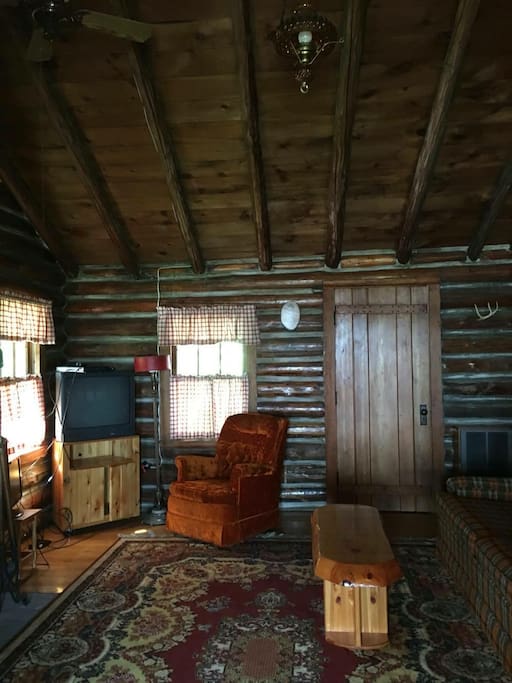 Another view of the living room with a view of the door leading to a bedroom