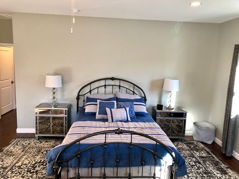 Largest bedroom with sofa and desk.