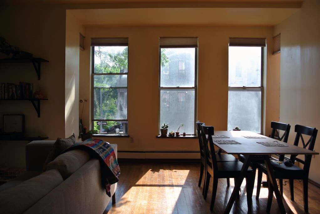 The living area is a spacious and bright room that includes a dining area