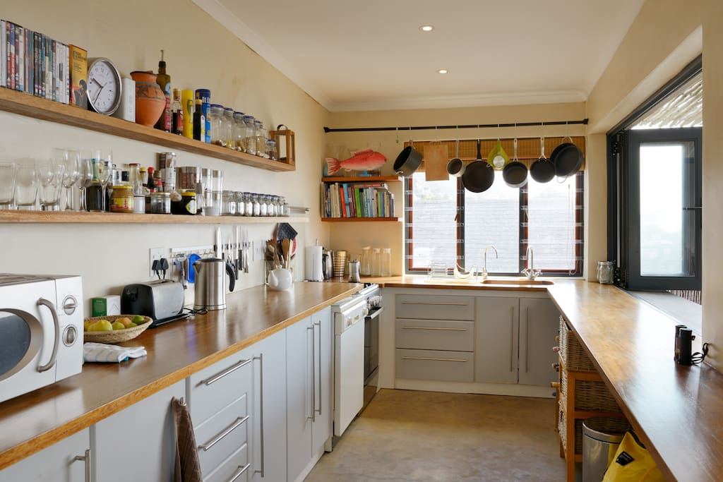 Wooden surfaces, dishwasher, cook with a view - counter is inside/ outside. Gas hob electric over.