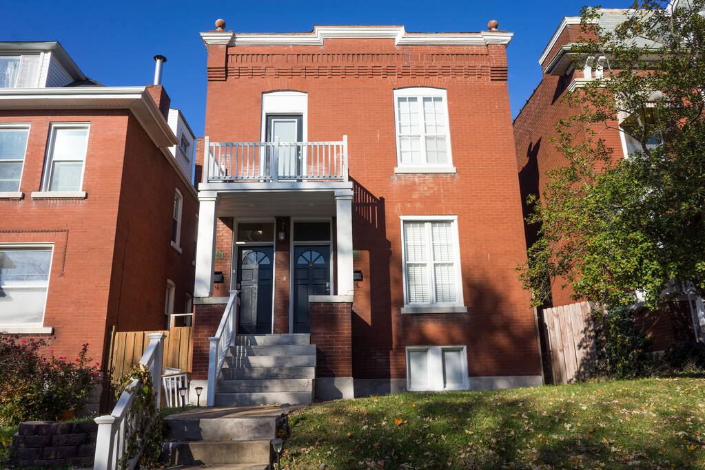 View of the front of the duplex, upstairs door to left, downstairs door to right
