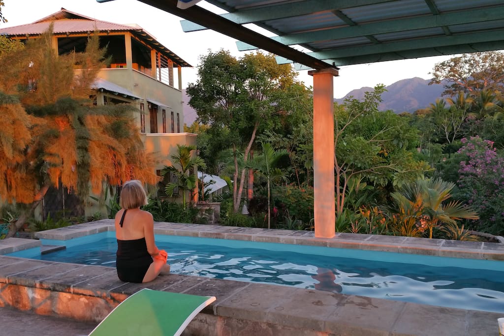 Cliffside pool with ocean and mountain views.