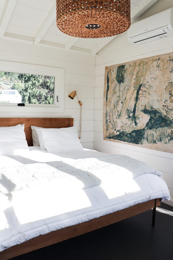Master bedroom with king bed and ocean views and vintage barn door