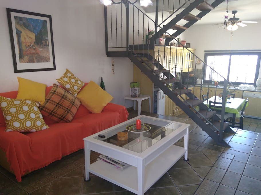The main living area is split level with the kitchen at the rear and the bedrooms upstairs.