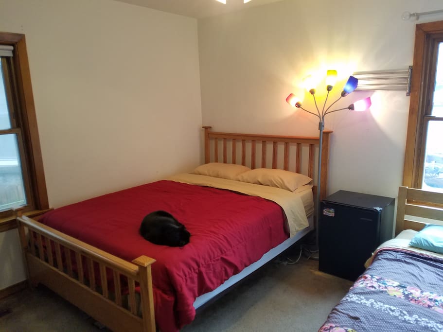 The queen bed in the room.
