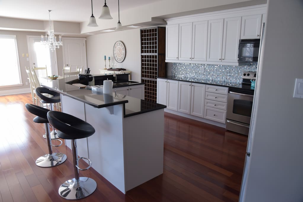 Gourmet full size kitchen with sit-up bar overlooking beautiful Lake Ontario