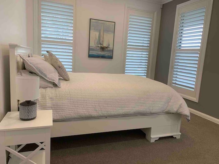 Spálňa/kancelária pre hostí na prízemí s manželskou posteľou Queen.