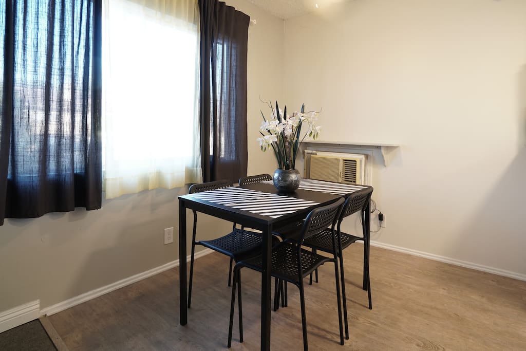 Dining area right outside of kitchen with ceiling fan