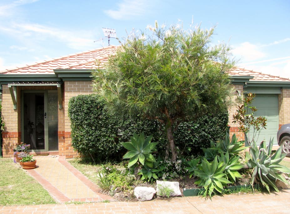 Front of house, parking space for two cars