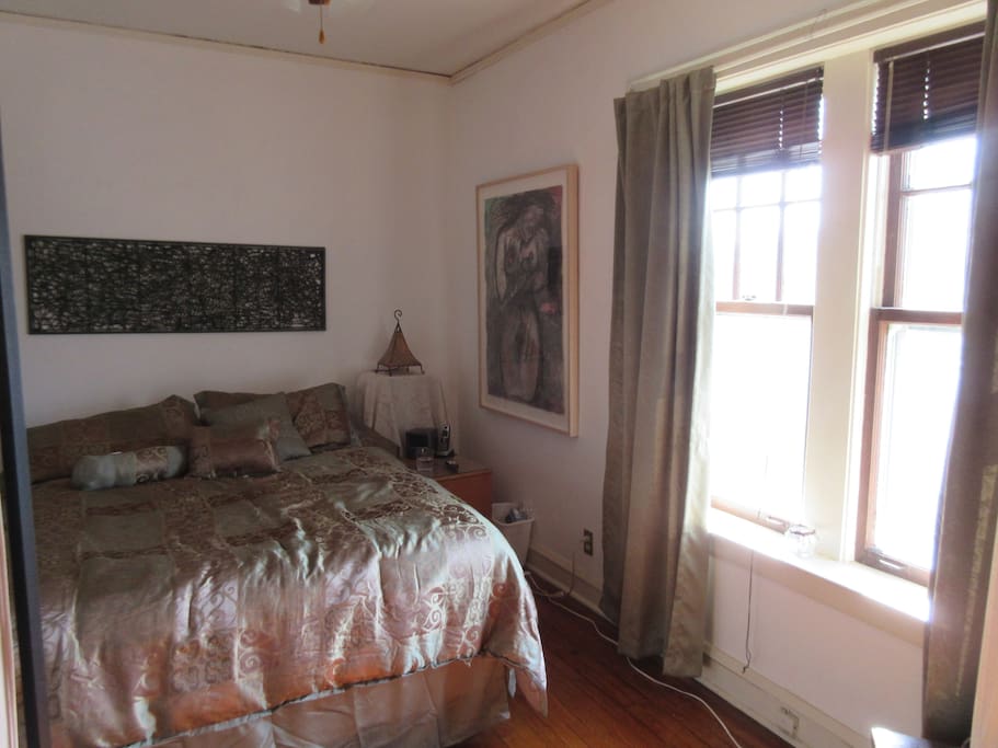 Bedroom 1 has a queen-sized bed, room darkening curtains and a TV.