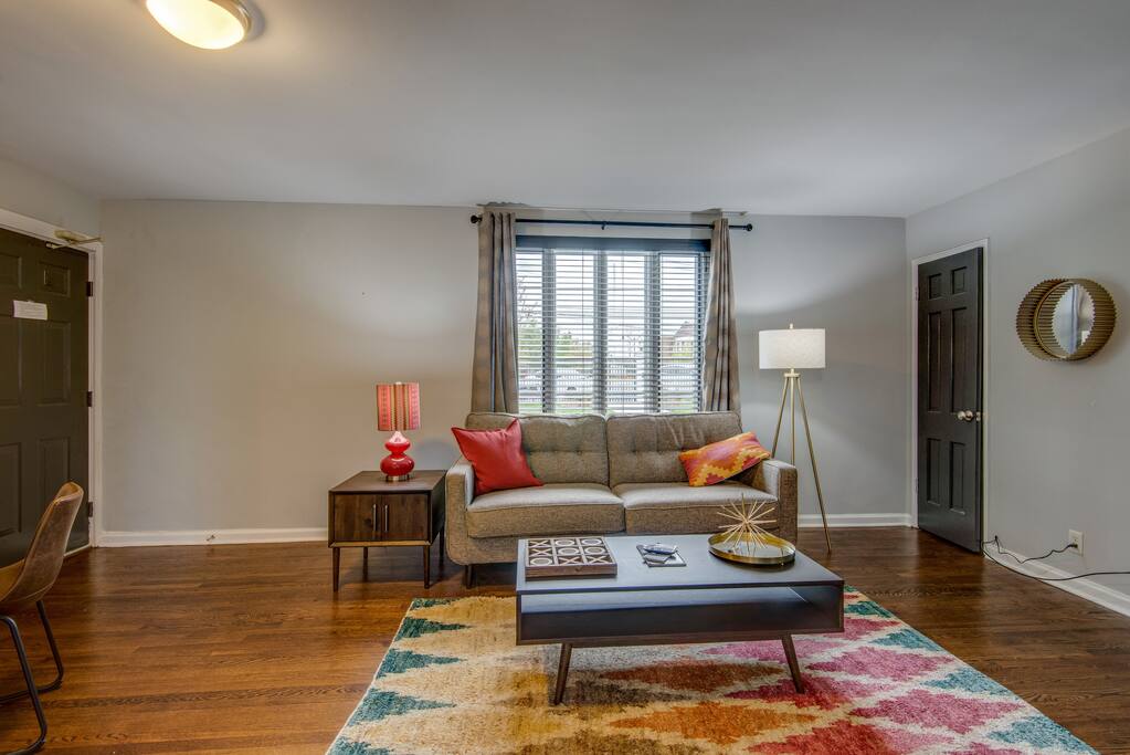 Living room with big window and comfy couch