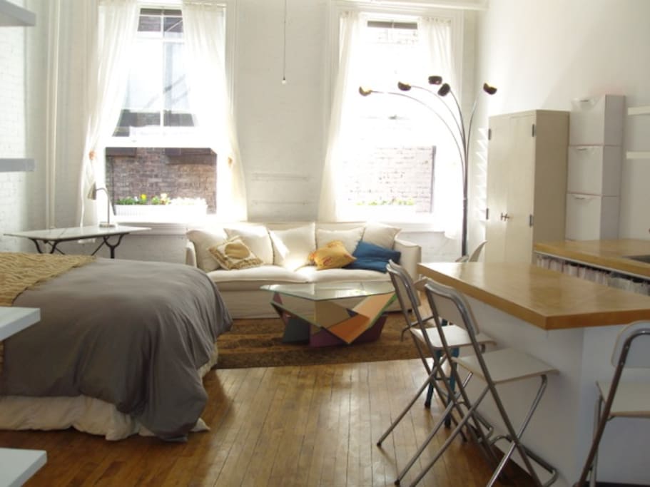 Queen size bed, couch, kitchen island