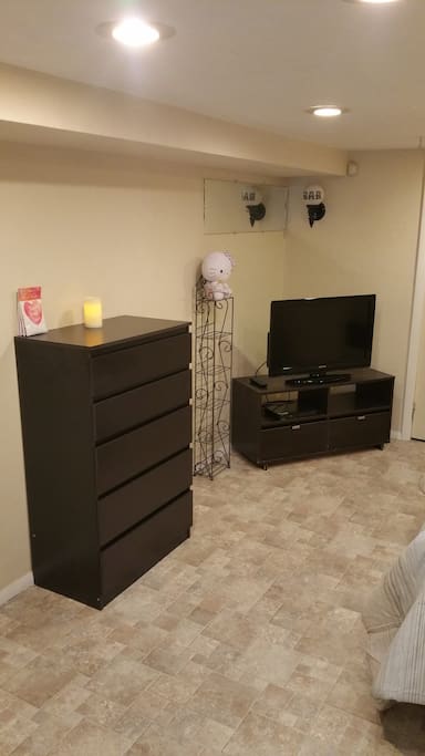 Main bedroom with dresser and T.V.