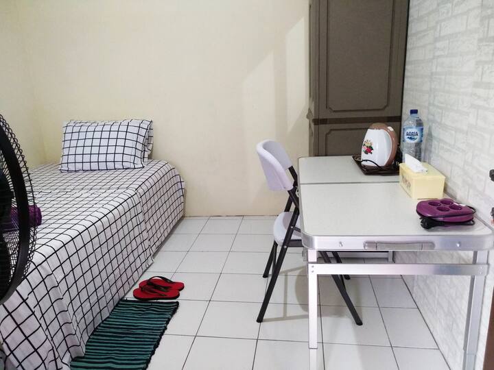 Room no.3 with bathroom outside room, no shower/no water heater, cupboard, table, chair, mirror, tea set, single bed. 