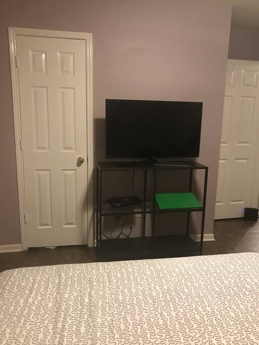 Closet door on the and tv, room door on the right