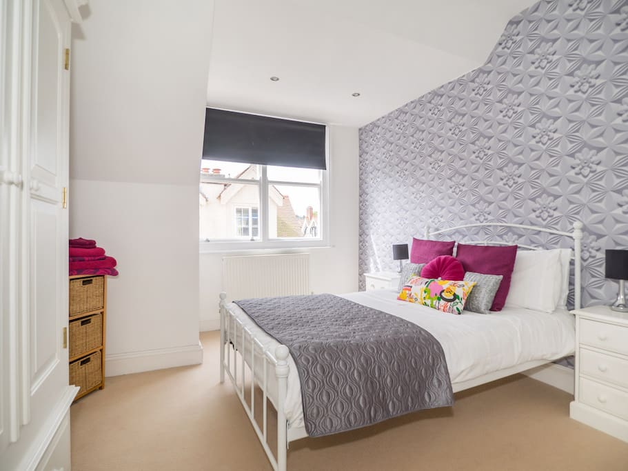 Stylish main bedroom with great storage and plenty of sun!