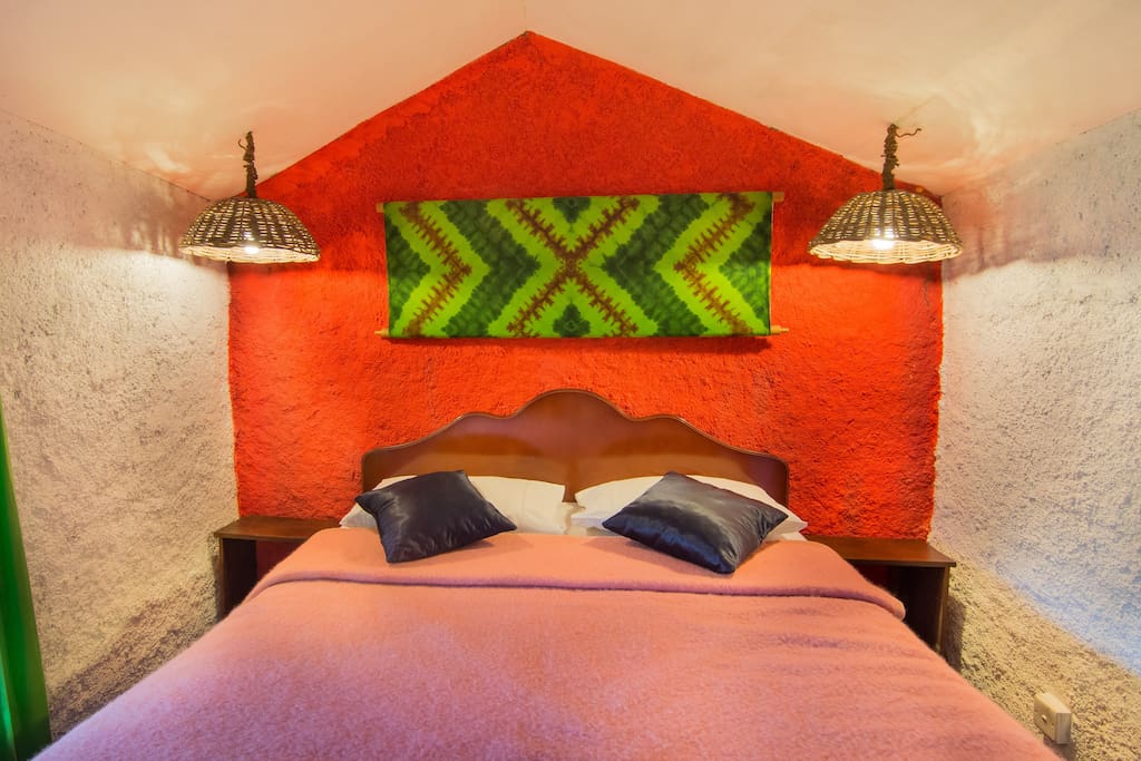 Queen size double bed in a little cozy room