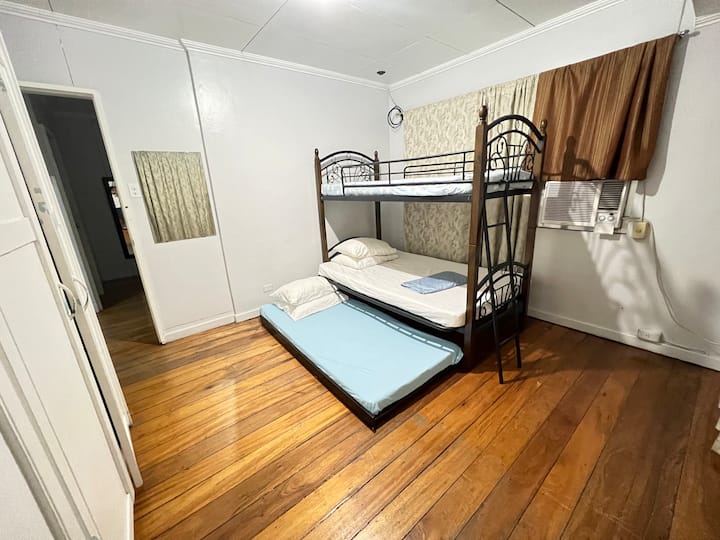 Bedroom 1 is equipped with a double deck bed and a convenient pull-out bed, making it ideal for families or groups. This arrangement maximizes sleeping space, and an extra mattress can be added if needed for additional comfort. 