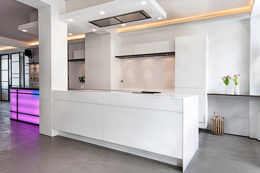 The kitchen is equipped with an inductive stovetop, a regular and a steam oven