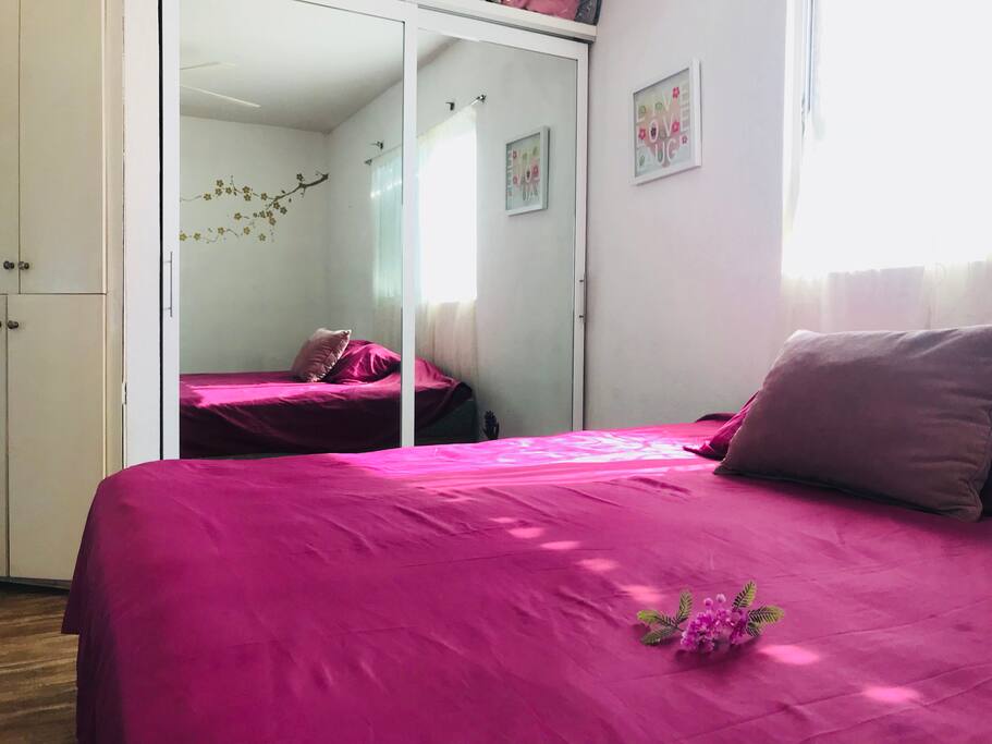 Main double bedroom with comfy king-sized bed, built in wardrobe.