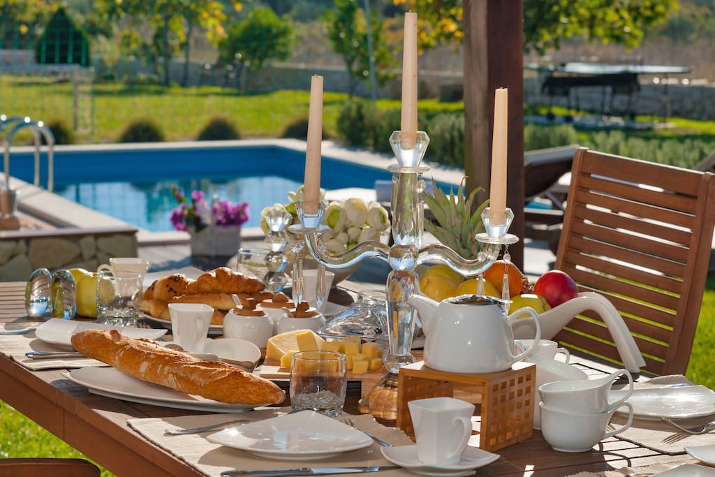 Open space dining table overlooking pool and large garden