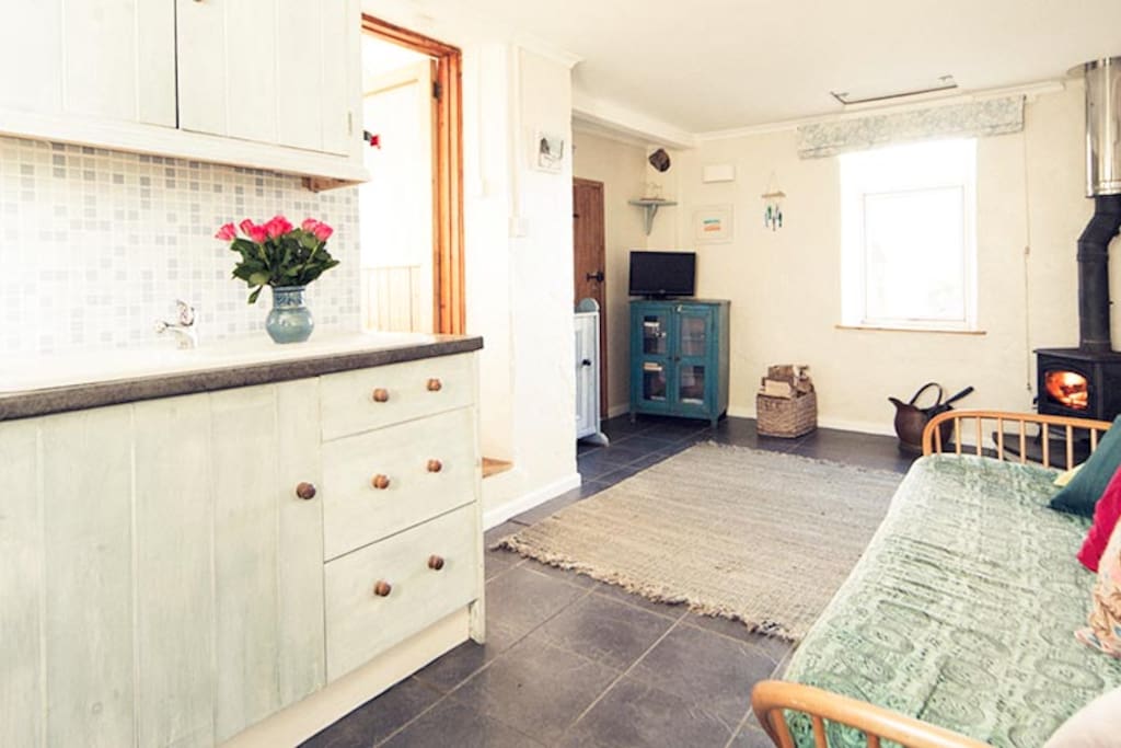 The kitchen living room with a comfortable Ercol day bed.