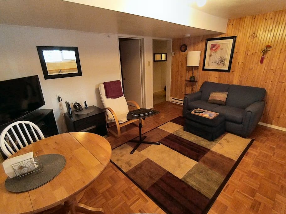 Living room, with TV, loveseat, dining table, WiFi