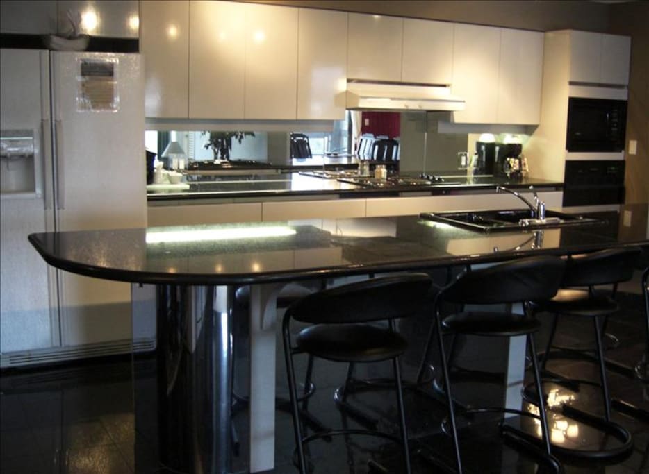 Modern fully-equipped kitchen with large granite island