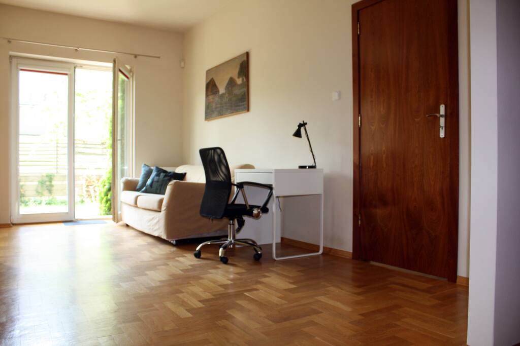 Living room - with a big folding sofa and a desk