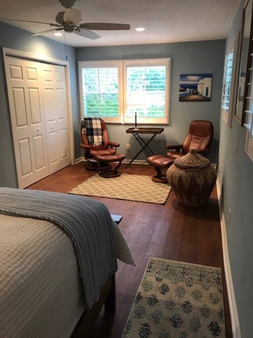 Wall mounted, flat screen tv viewable from the bed and sitting area.