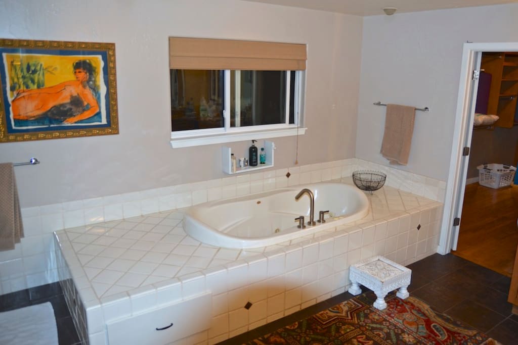 Private attached Master bathroom with large jacuzzi tub and walk in shower
