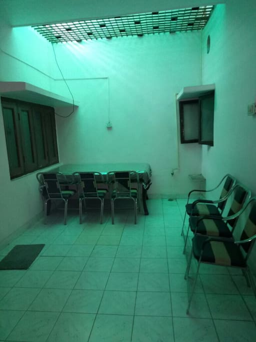 Dining area with ample chairs and attached kitchen.